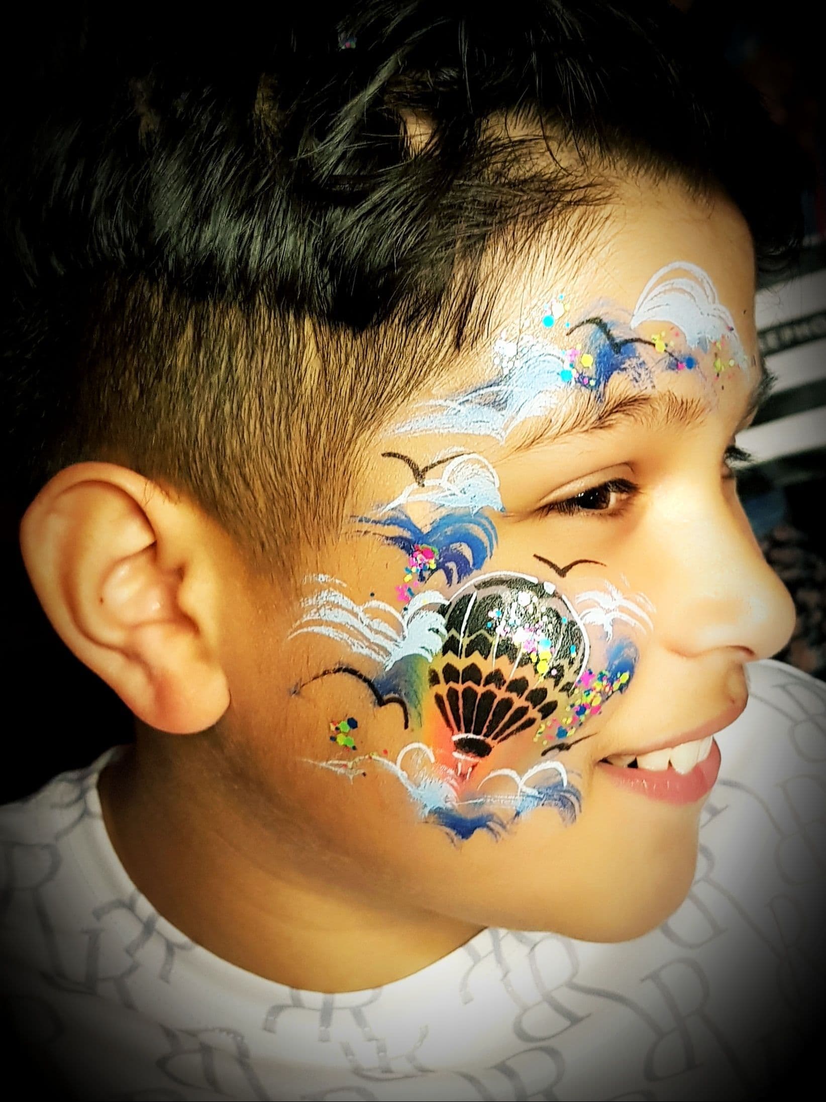 A young child with their face painted.