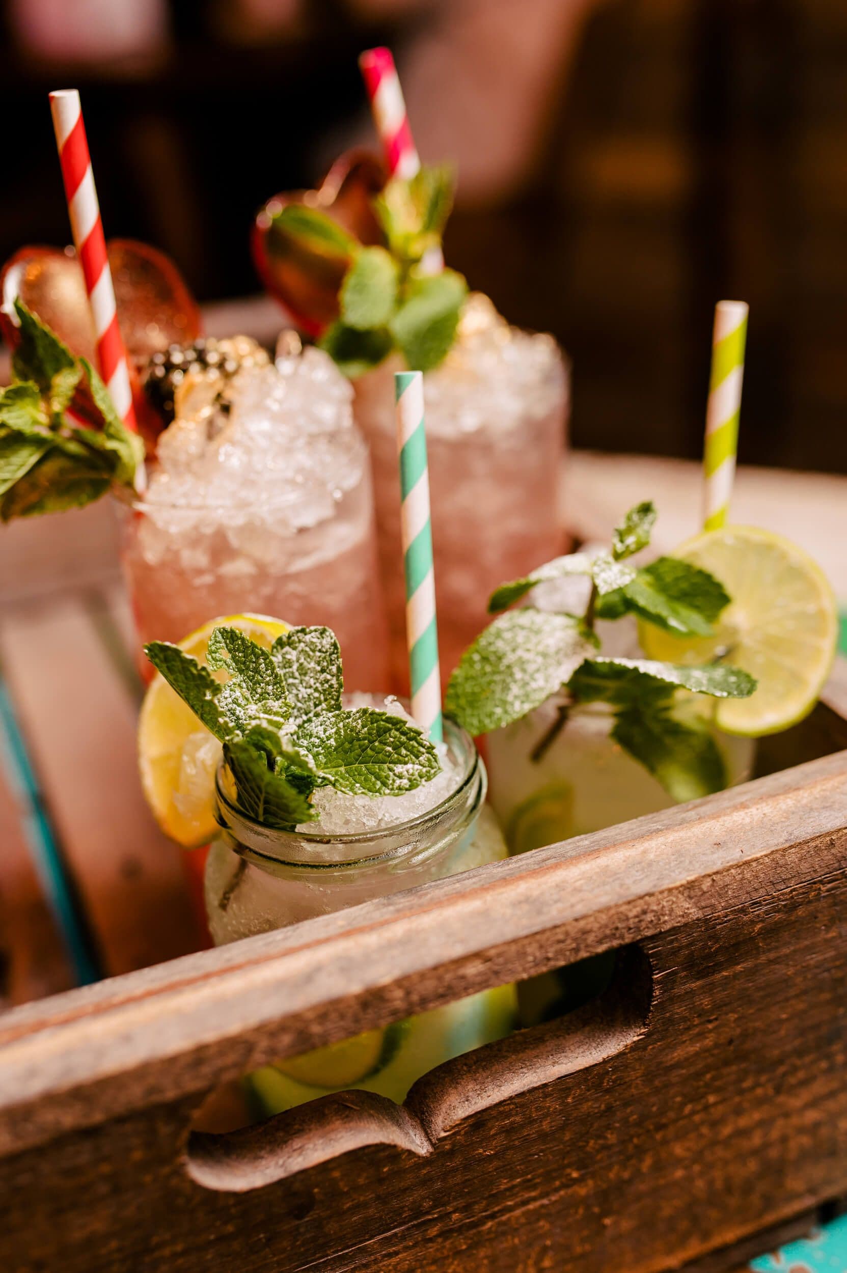 A selection of mocktails displayed inside a wooden box at Treetop Golf.