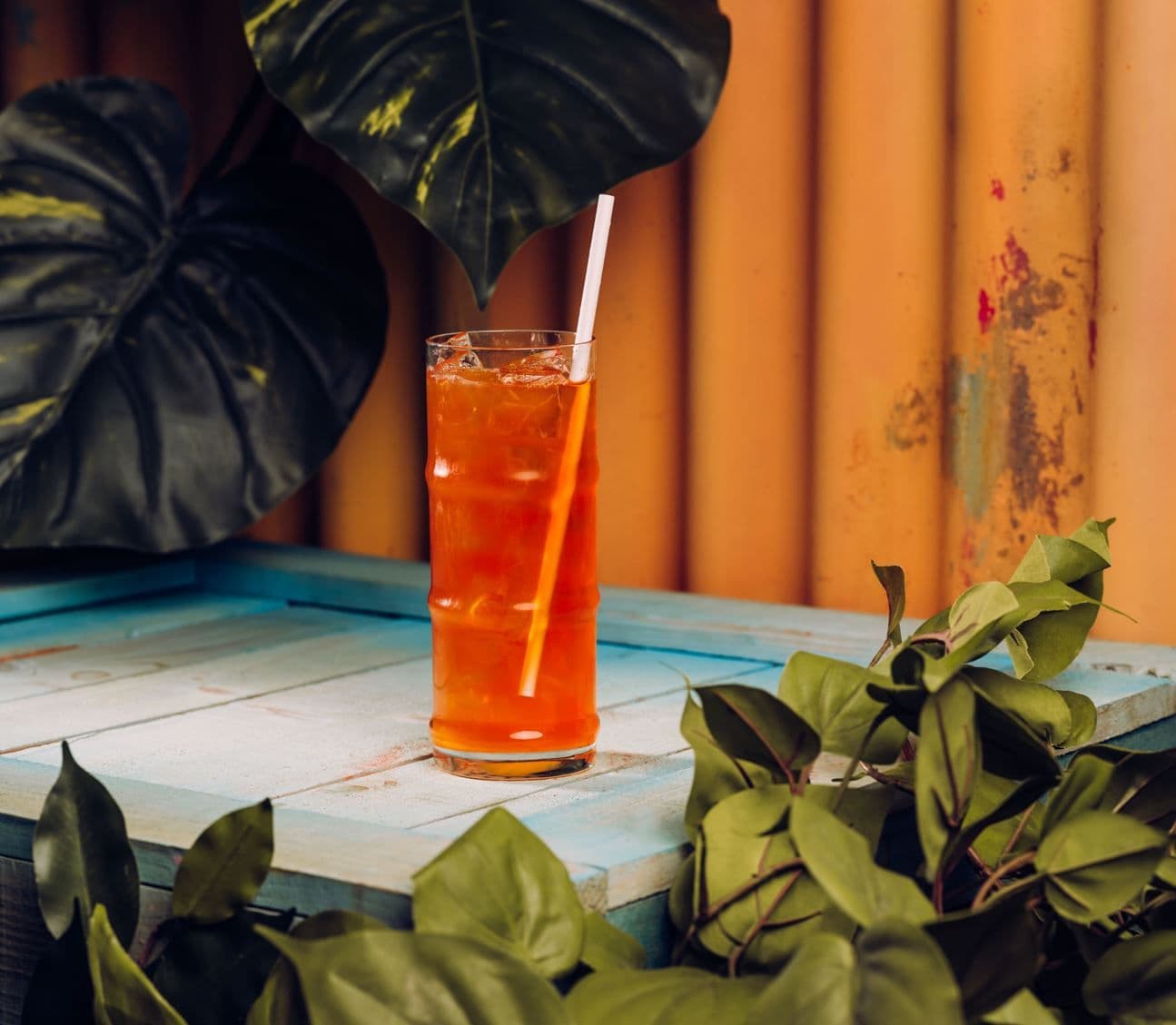 A peach iced tea displayed on a table.