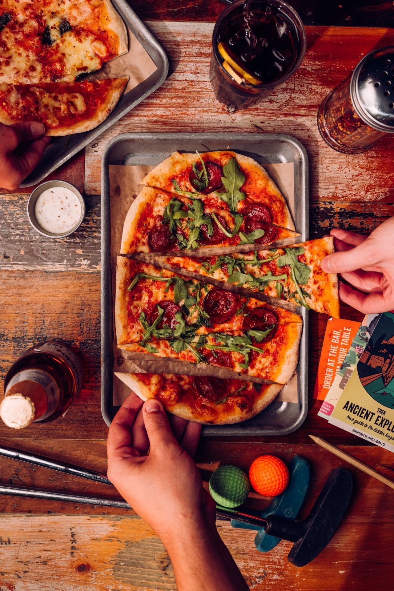 People tucking into a Sizzle and Swing Pizza