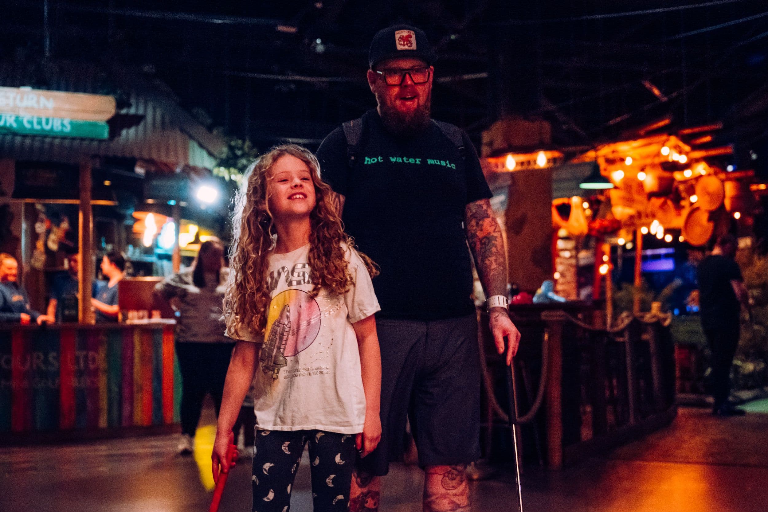 A father and daughter playing mini golf at Treetop