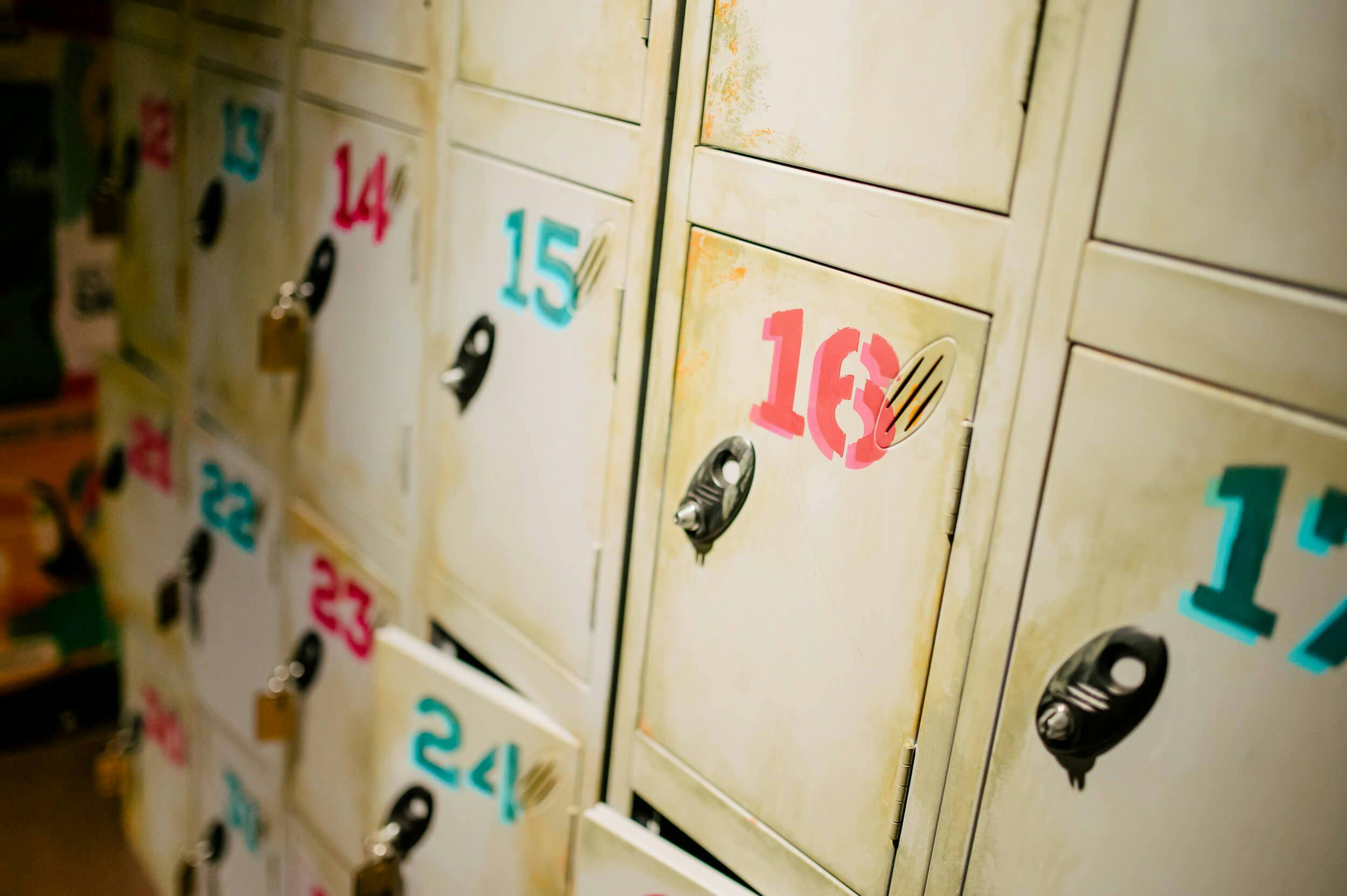 Close up image of on-site lockers; with bold fluro-coloured numbers printed on each.