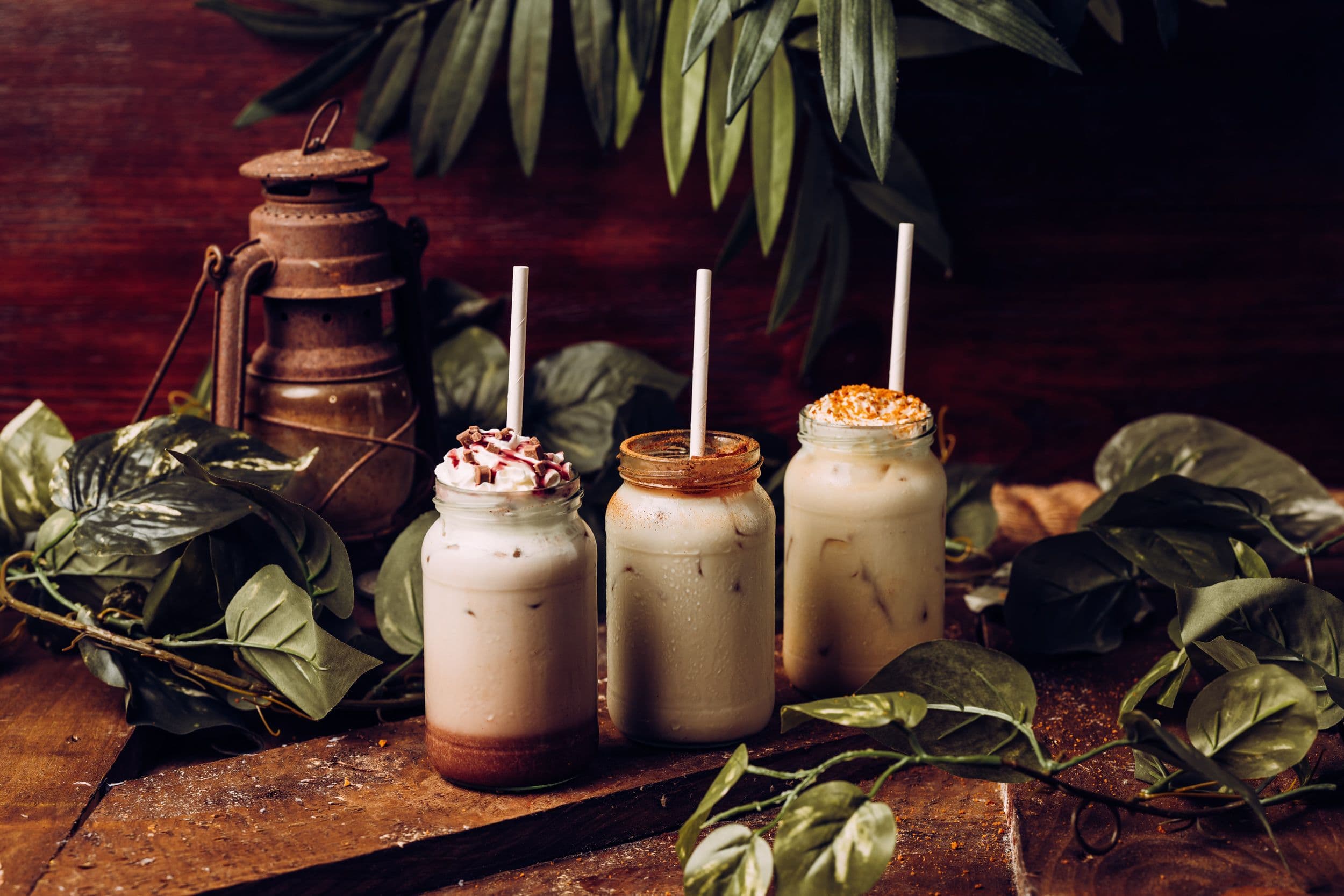 Three festive iced drinks lined up on a table.