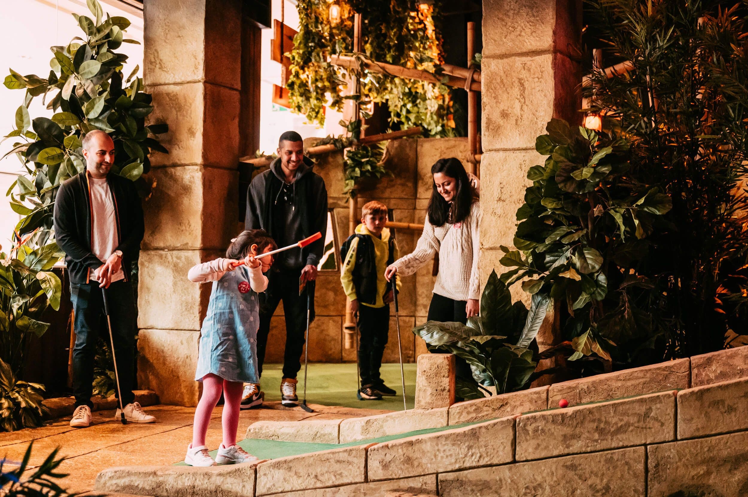 Image of a family playing the Ancient Explorer course, surrounded by crumbling temples. 