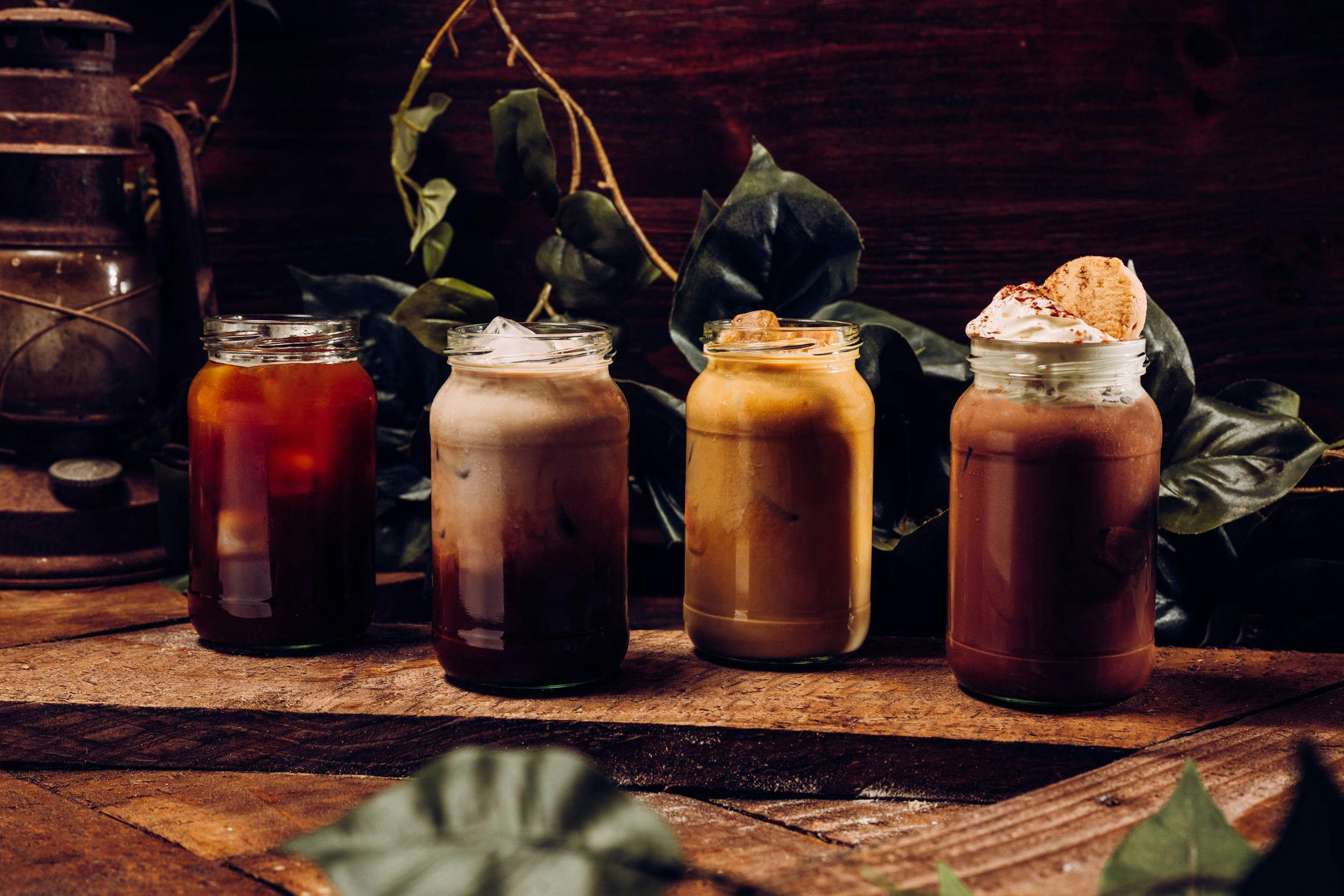 A close up image of four iced drinks in a row.