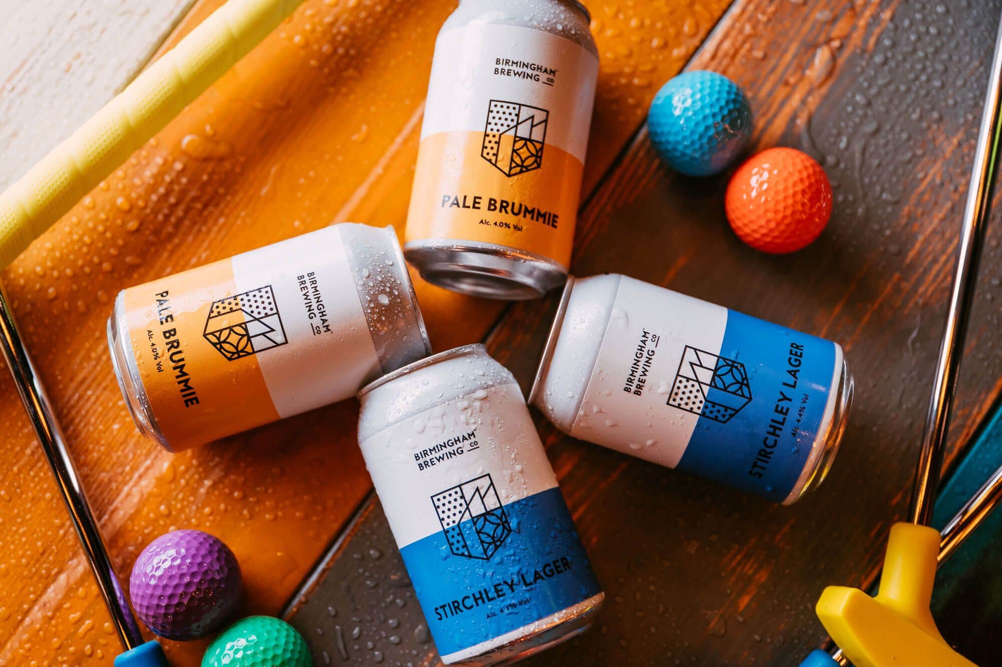 A birds-eye-view image of local craft beers from the Birmingham Brewery Co on a table surrounded by bright mini golf balls.